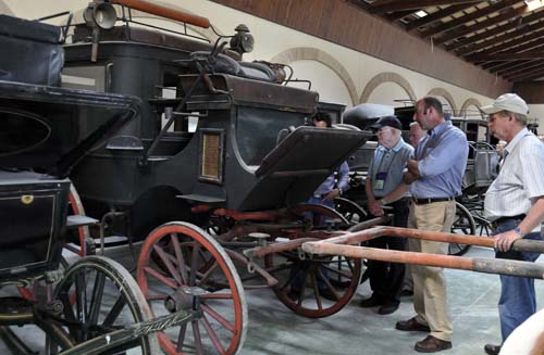 David Freedman and several members of the group discuss one of Miguel's yet-to-be-restored carriages