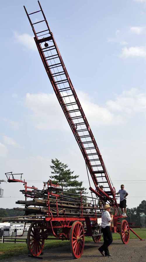 © Jennifer Singleton – Please do not copy or save without permission Willi explained how the ladder wagon would've worked, while a couple of volunteers hand-cranked the main ladder to a portion of its 65-foot height