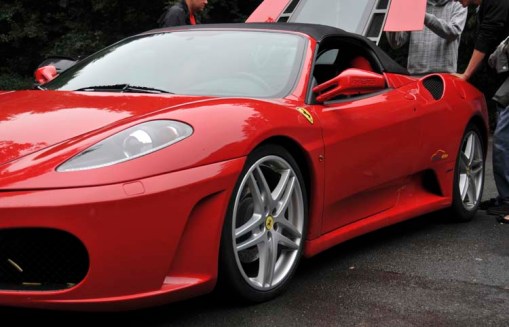 the fabulous-looking Ferrari that A.J. wanted to trade for the mini-bus; the hood in back is open as potential test-drivers admire the engine