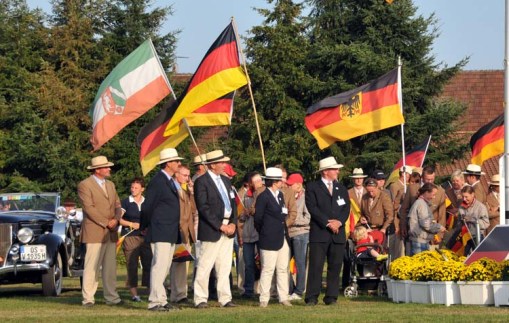more of the German team members, grooms, families, etc. ... standing next to the podium and watching the proceedings